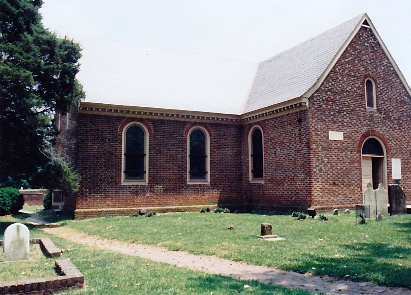 Old Blandford Church exterior in Petersburg, Virginia, showing the 1736 stone church with historic cemetery grounds