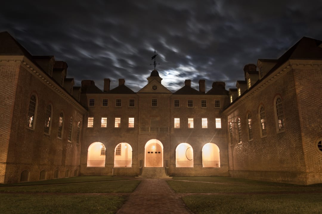 The Wren Building's illuminated rear courtyard arcade at night, College of William & Mary, Williamsburg, Virginia.