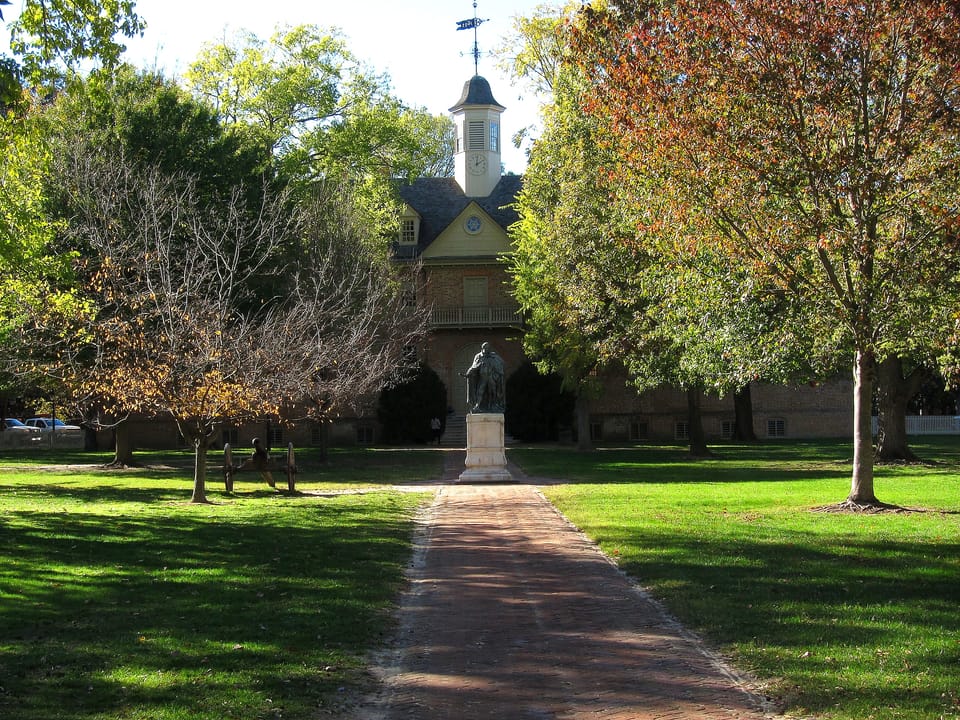 The Wren Building's front elevation and cupola in autumn, viewed along the brick walk from the Lord Botetourt statue, College of William & Mary, Williamsburg, Virginia.