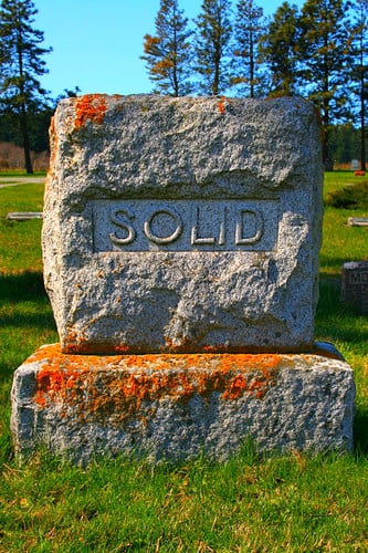 Sunnyside Cemetery on a bluff above Ebey's Prairie in Coupeville, Washington, with historic headstones and the Olympic Mountains beyond