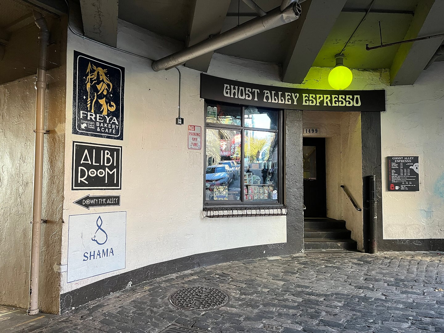 Ghost Alley Espresso storefront sign on Post Alley in Pike Place Market, Seattle, Washington