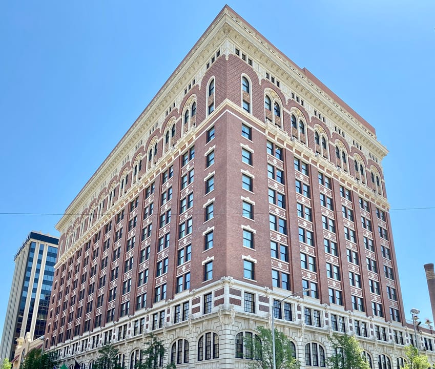 A dramatic upward view of the Historic Davenport Hotel's brick and terra cotta tower against the sky, Spokane, Washington