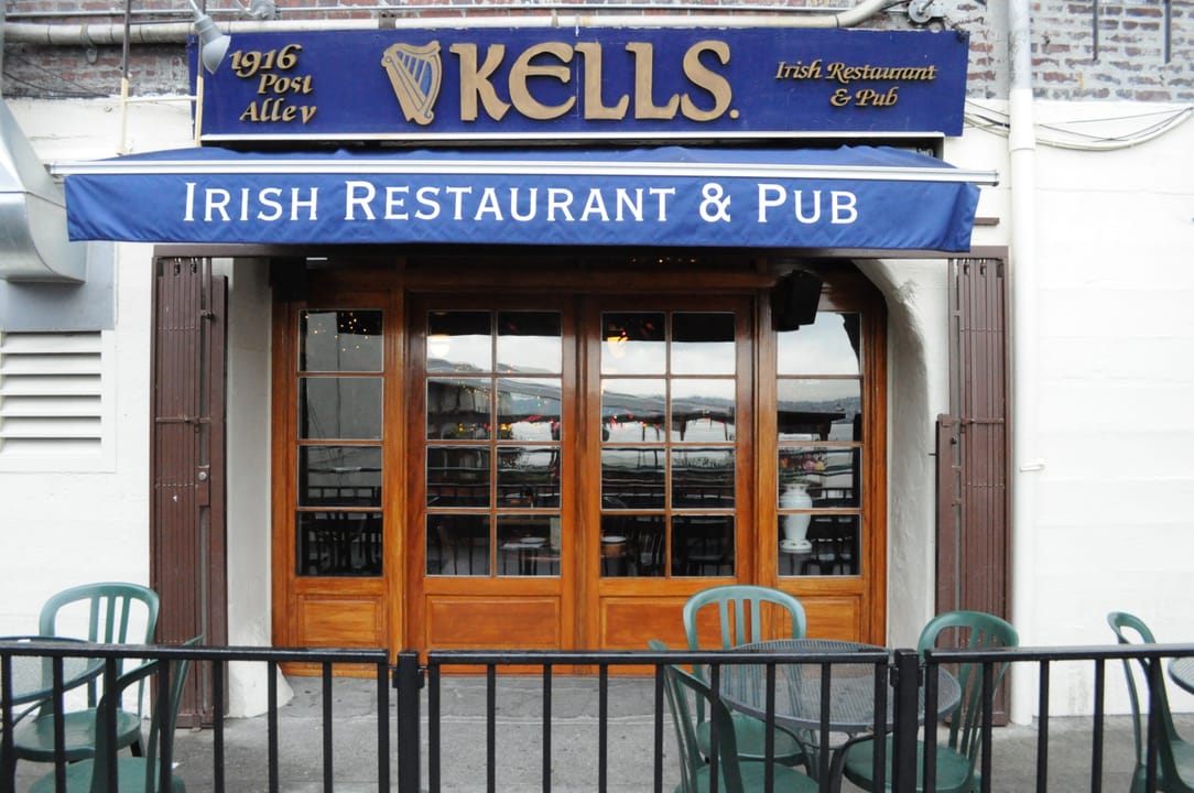 Kells' Post Alley entrance at the rear of the Butterworth Building; the awning reads '1916 Post Alley -- Kells Irish Restaurant & Pub.'