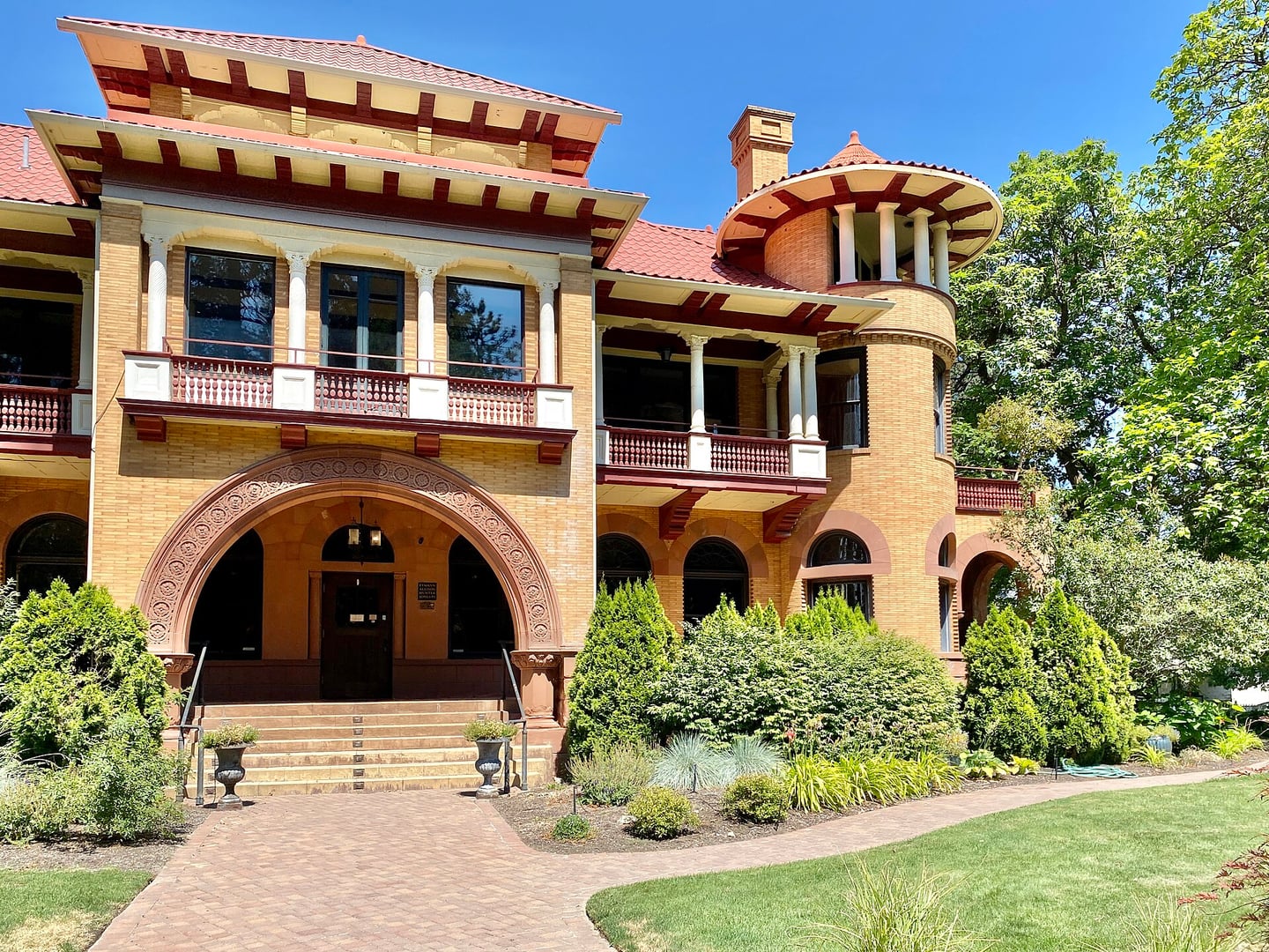Patsy Clark Mansion at 2nd Avenue and Hemlock Street in Browne's Addition, Spokane, Washington, showing buff brick exterior with conical corner towers