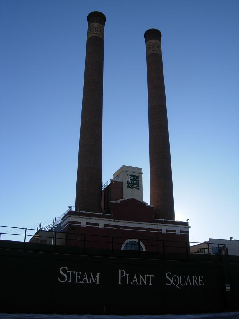 Exterior of the Central Steam Heat Plant (Steam Plant Square) in downtown Spokane, Washington, showing the twin 225-foot brick smokestacks