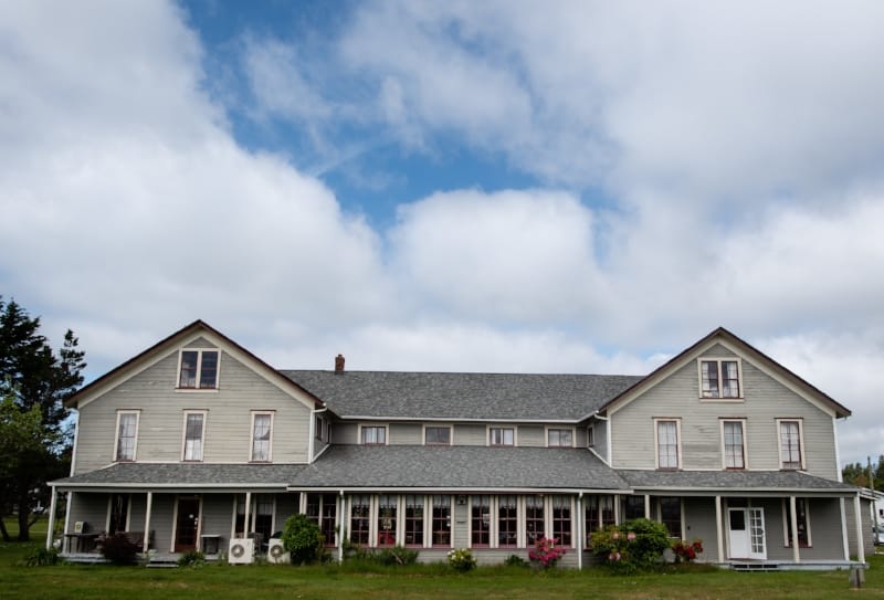 The Tokeland Hotel's front porch and lawn, a straight-on view of the National Register-listed building.