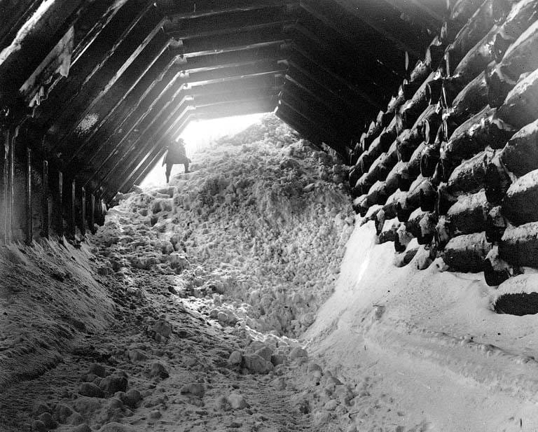 Avalanche debris piled inside the end of a timber snowshed at Wellington, 1910.