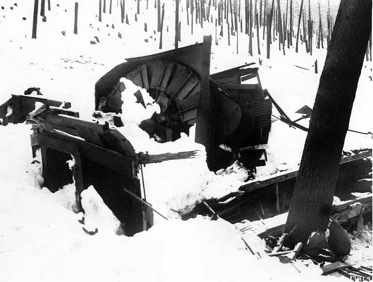 The wrecked rotary snowplow at Wellington after the March 1, 1910 avalanche, half-buried in snow among splintered timber.
