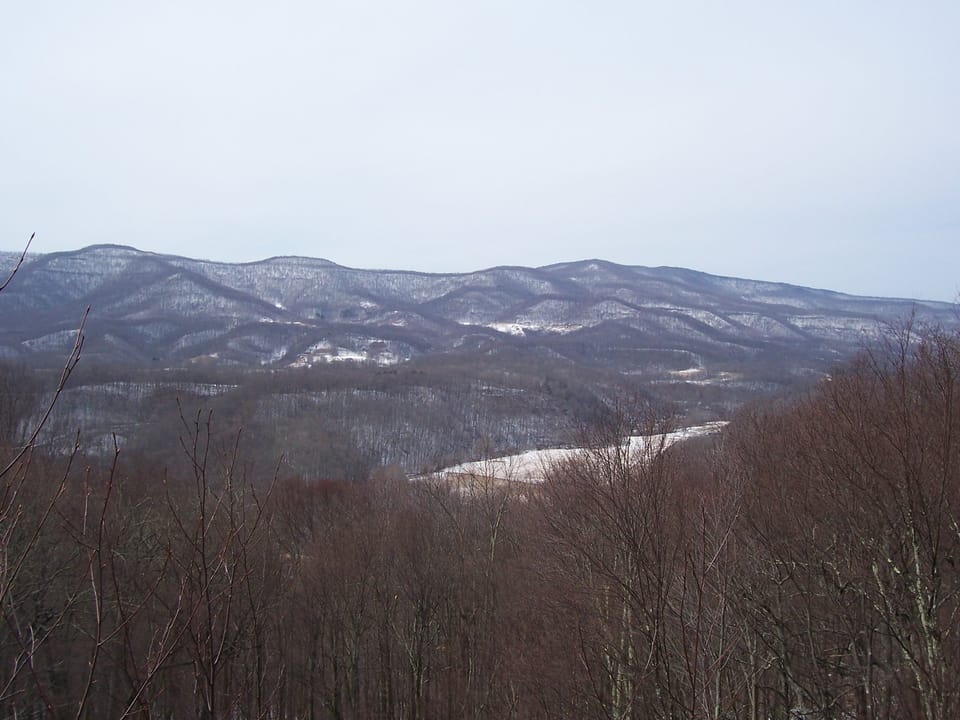 A daytime view over the surrounding Pocahontas County hills from an overlook at Droop Mountain Battlefield State Park