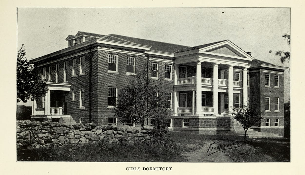 The girls' dormitory of Shepherd College State Normal School in Shepherdstown, West Virginia, the building now called Miller Hall: a three-storey brick building with a two-storey pedimented portico and a columned end porch, in a photograph dated 1916