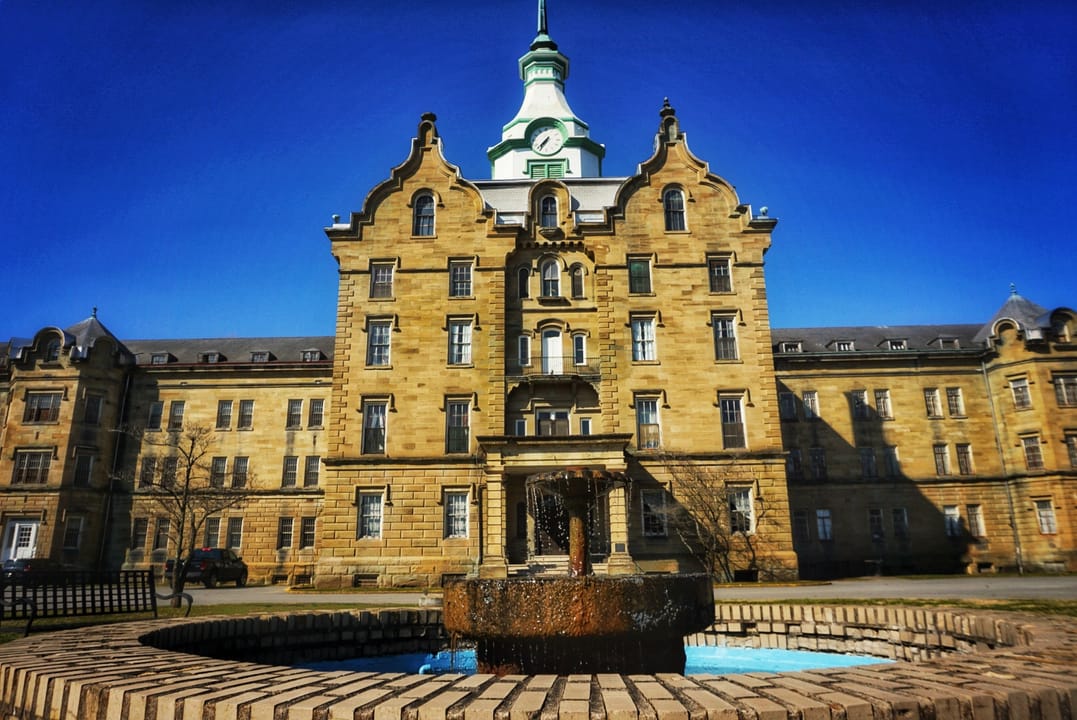 The Trans-Allegheny Lunatic Asylum (Weston State Hospital), Weston, West Virginia, a close frontal view with the entrance fountain, February 2019.