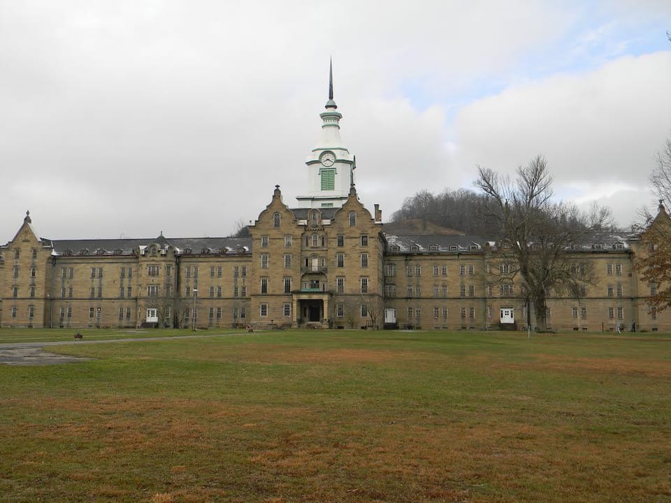 The Trans-Allegheny Lunatic Asylum (Weston State Hospital), Weston, West Virginia, a wide exterior view across the lawn under an overcast sky, December 2012.