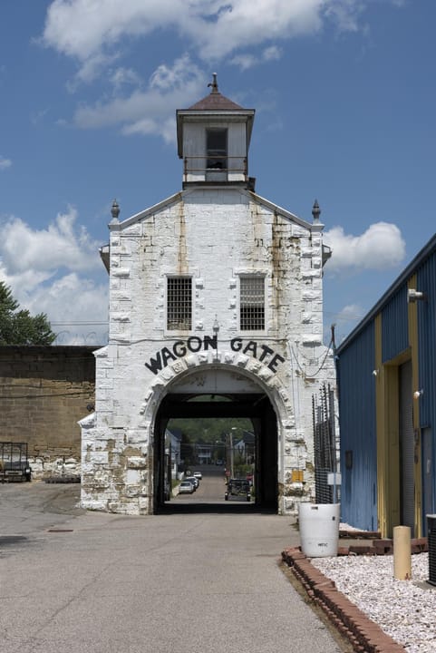 The Wagon Gate entrance to the West Virginia State Penitentiary, Moundsville, West Virginia, with its painted stone archway reading 'WAGON GATE'.