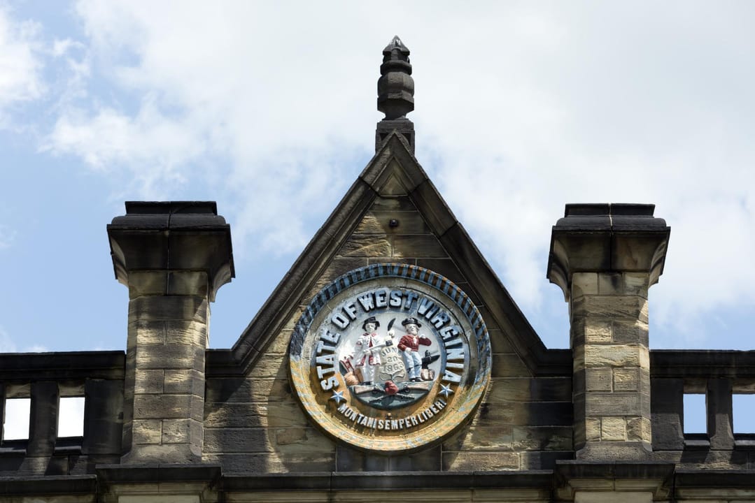 The West Virginia state seal set into the stone pediment above the penitentiary's main entrance.