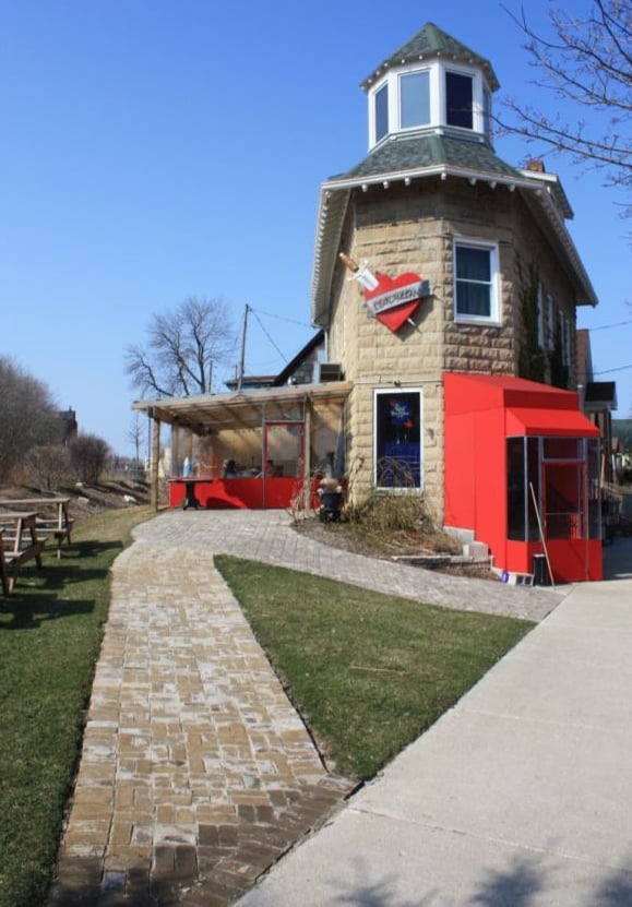 Cafe Corazon Riverwest distinctive triangular brick corner storefront at 3129 N Bremen St in Milwaukee's Riverwest neighborhood, decorated with a heart sign