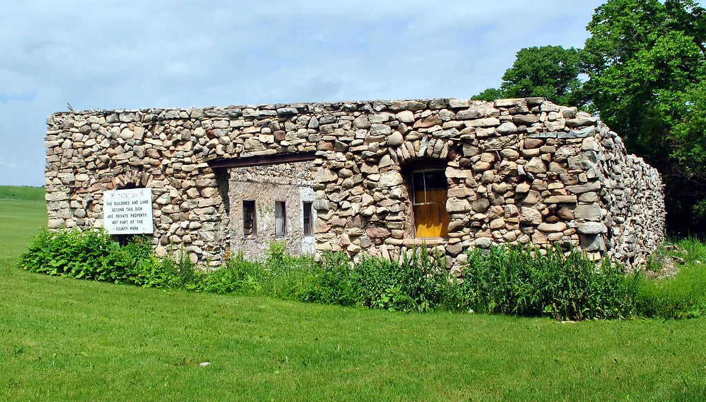 Collapsed limestone ruins of the Maribel Caves Hotel in the woods near Maribel, Wisconsin