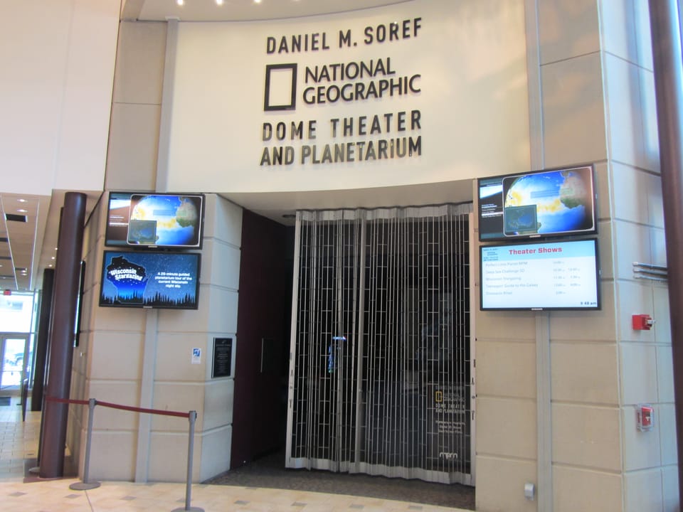 The entrance to the Daniel M. Soref National Geographic Dome Theater and Planetarium inside the Milwaukee Public Museum, with signage visible.