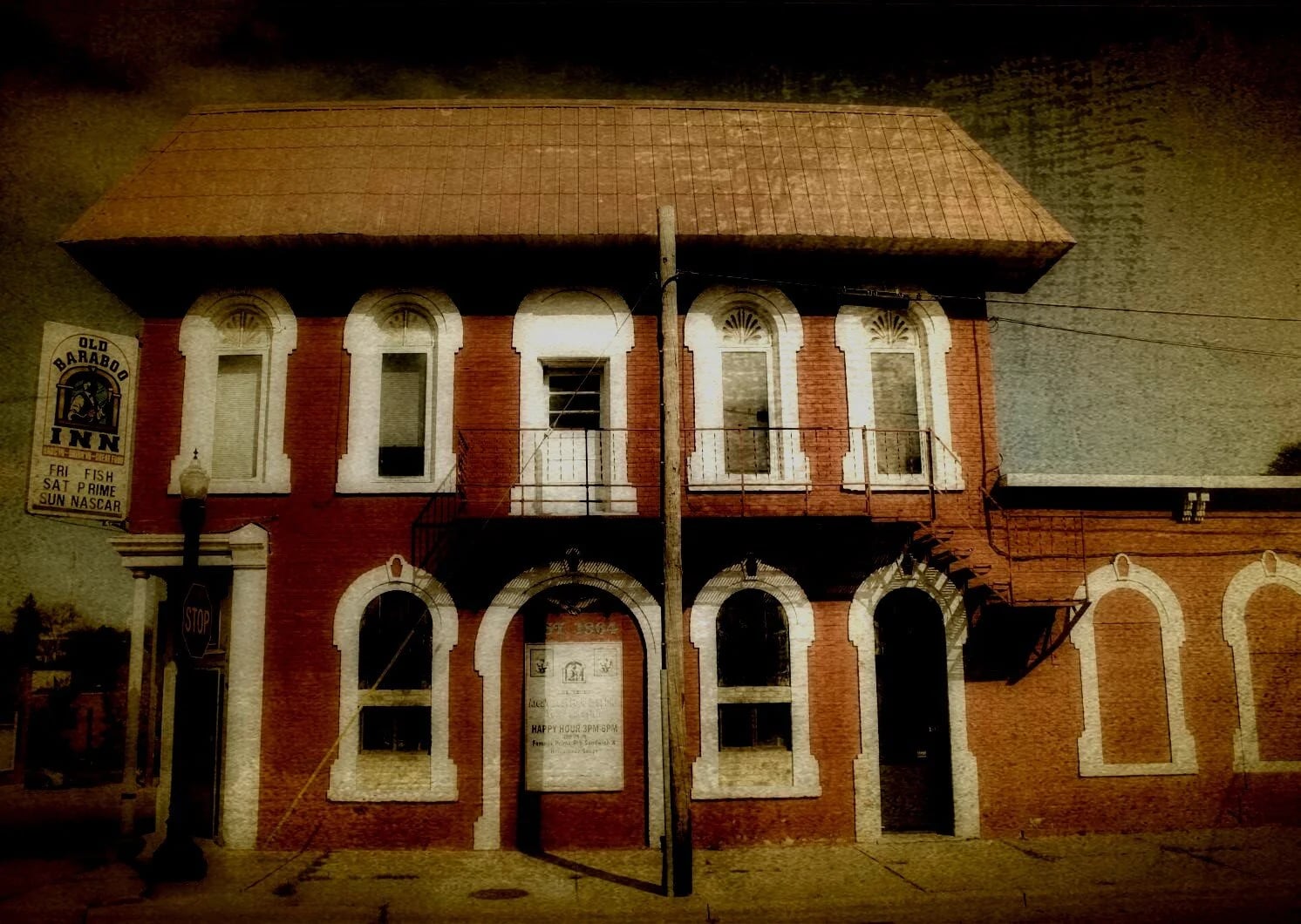 Old Baraboo Inn exterior at 135 Walnut Street, Baraboo, Wisconsin — three-story 1864 brick building