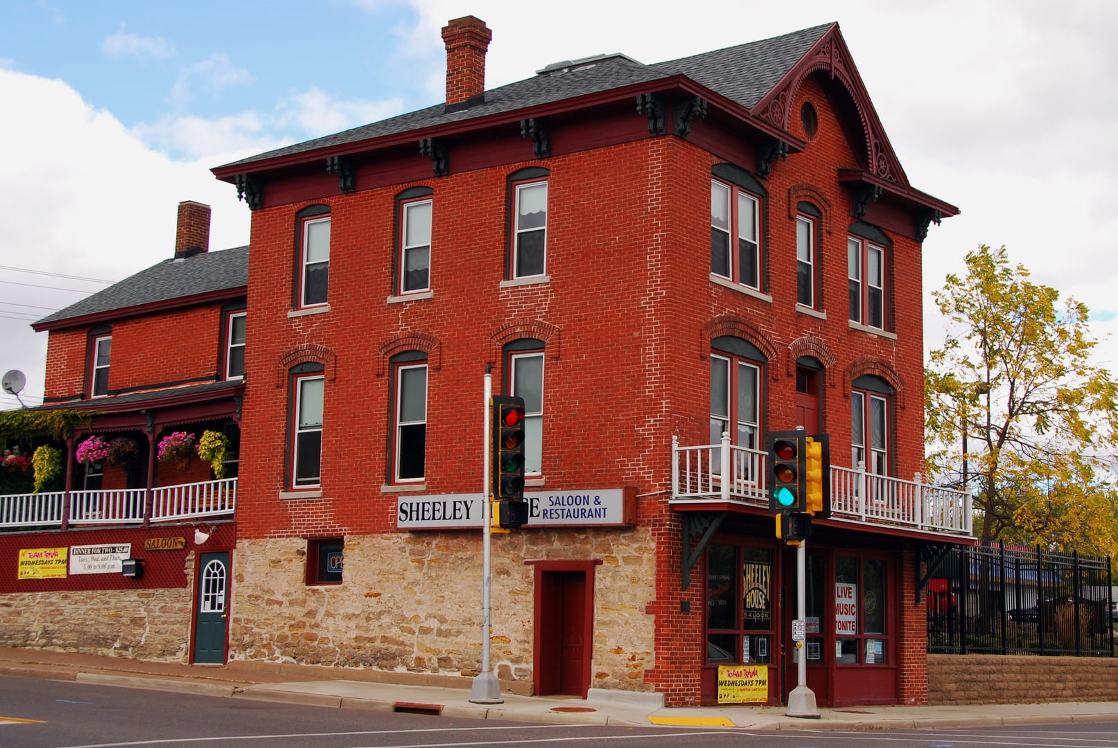 Red brick Italianate facade of the James Sheeley House Saloon on West River Street in Chippewa Falls, Wisconsin — a 19th-century boardinghouse on the National Register