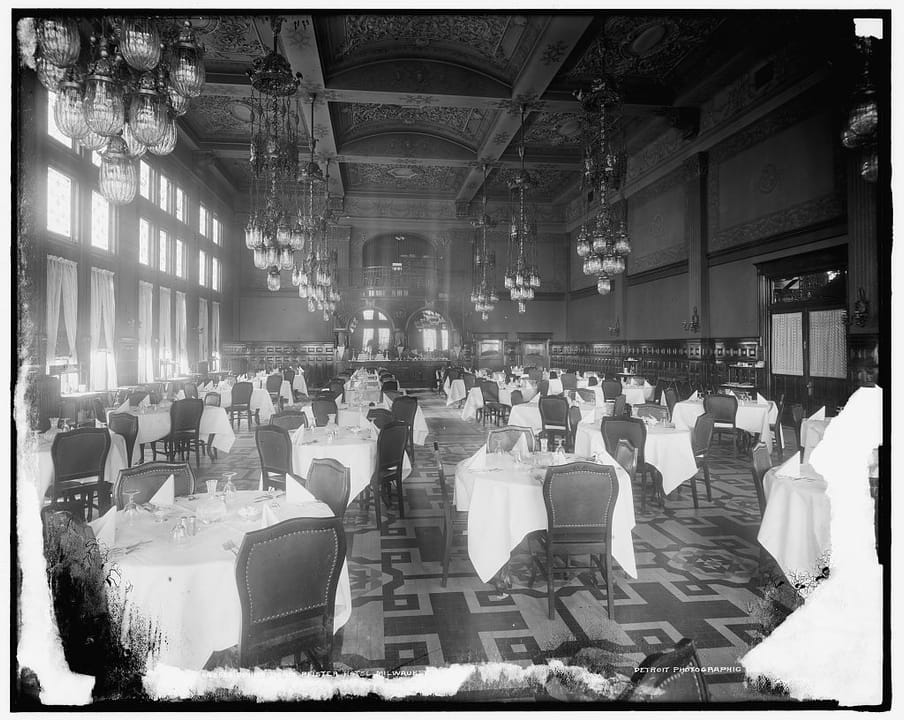 The grand dining room at the Pfister Hotel, c.1900-1905, set for a banquet beneath its chandeliers and vaulted skylights.