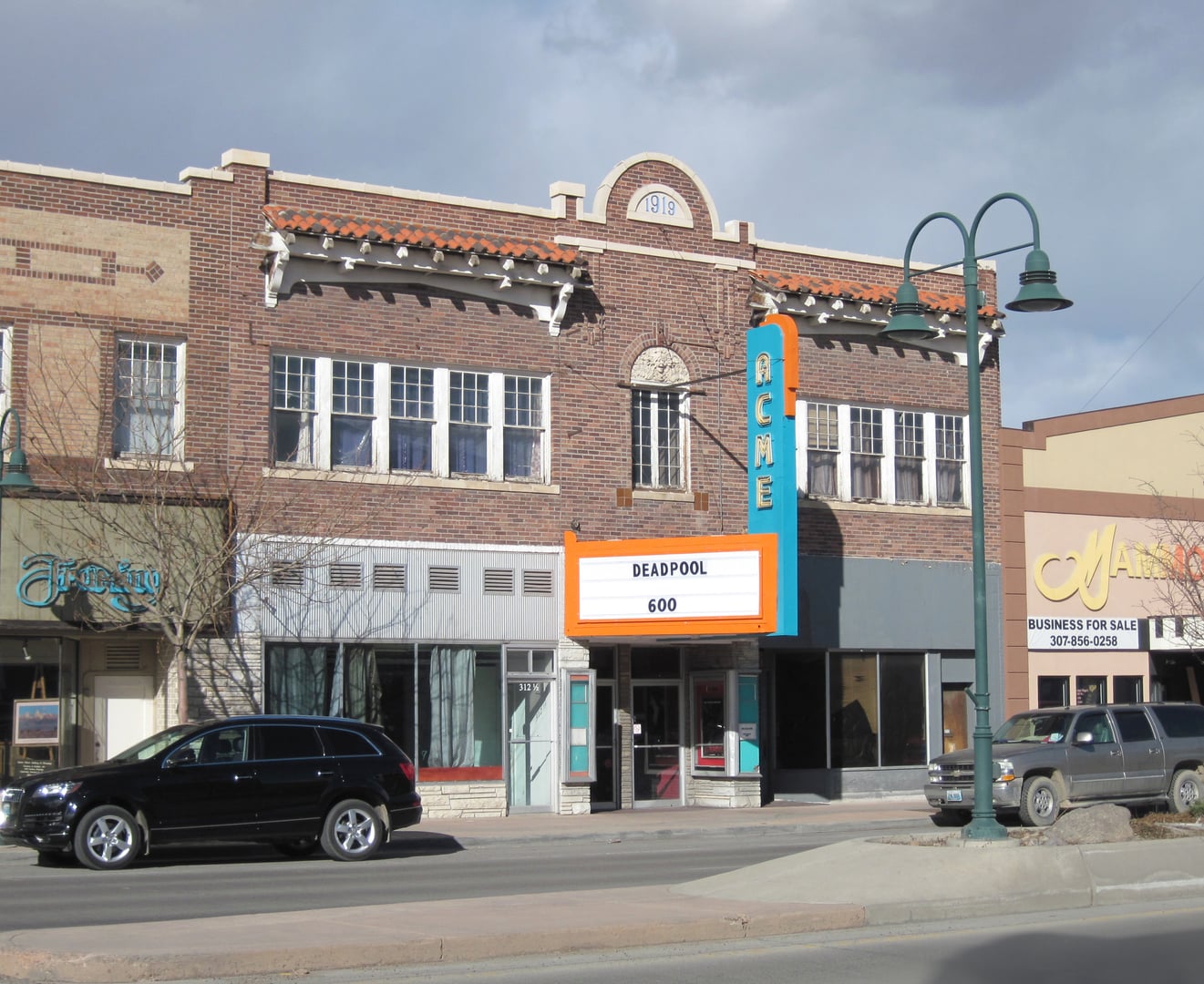 Brick facade of the 1920 Acme Theater in downtown Riverton, Wyoming, with vintage marquee signage along East Main Street.