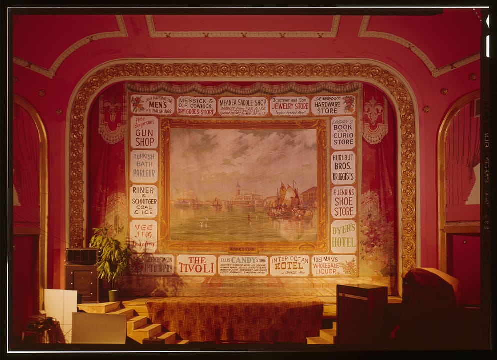 The Atlas Theatre's hand-painted advertising drop curtain above the stage, Cheyenne, Wyoming, in a color transparency from the Historic American Buildings Survey documentation (HABS No. WYO-77).