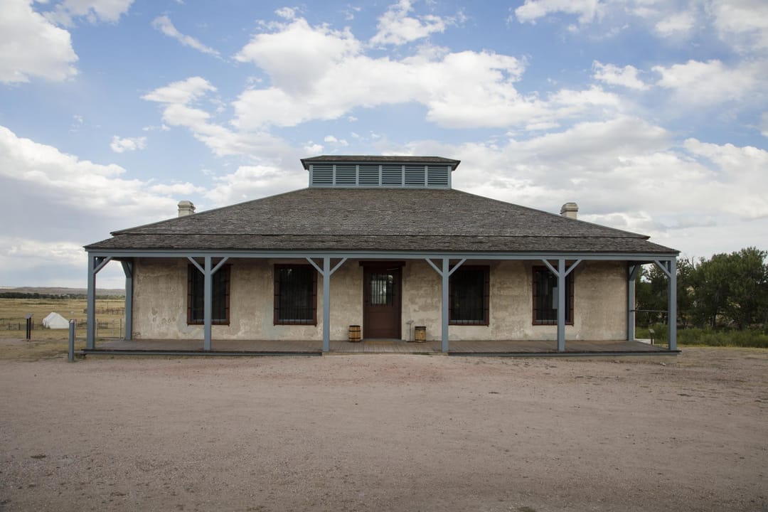 Old Bedlam, built in 1849 and (per the LOC record, as of 2015) the oldest standing building in Wyoming -- the fort's signature structure, former bachelor officers' quarters, shown front-on with its two-tier porch.