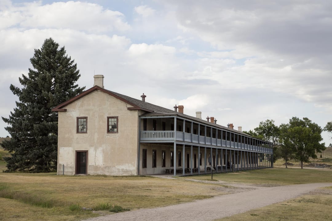 The old cavalry barracks at Fort Laramie -- a long two-story building with wraparound porches on both levels.