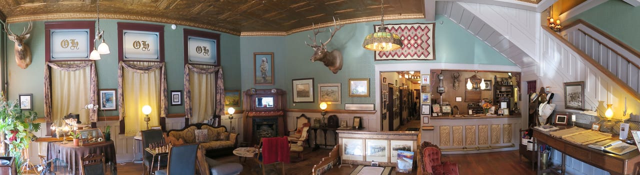 Interior panorama of the Occidental Hotel's bar and sitting area in Buffalo, Wyoming, with mounted trophy heads on the wall, 2017.