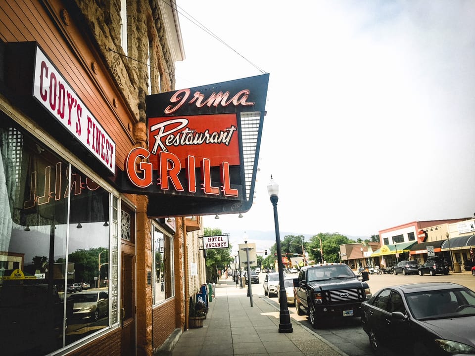 The 'Irma Restaurant Grill' sign on Buffalo Bill's Irma Hotel, viewed from the Sheridan Avenue sidewalk, Cody, Wyoming.