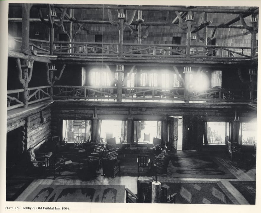 The famous log-and-timber lobby of the Old Faithful Inn, with its massive stone fireplace, photographed the year the hotel opened, 1904.